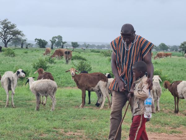 Pater Frederick Agame, (Pfarrer der Herz-Jesu-Pfarrei Bansang) mit einem jungen Hirten in Sare-Abdul.